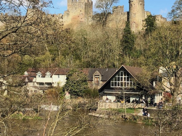 A river and on the far bank old houses in the distance a castle