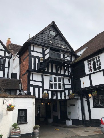 An old, maybe elizabethan building. painted black and white
