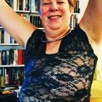 Me wearing a lacy, see through dress with arms raised in celebration.