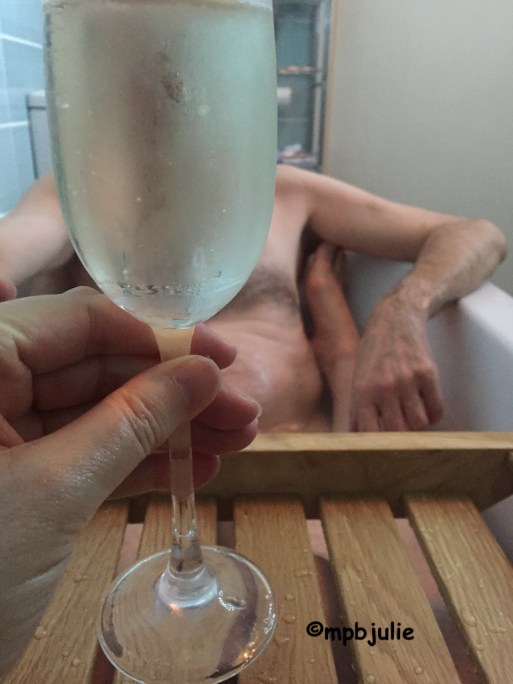 We are in the bath. All you can see is my hand and a glass of Champagne. Plus at the other end master obscured by the glass. You can see his hand and arms as well as a little of his body. Plus one of my feet.