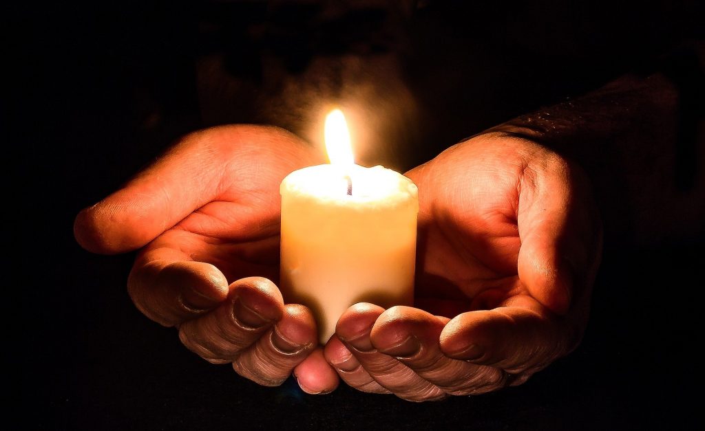 Candle held in two hands