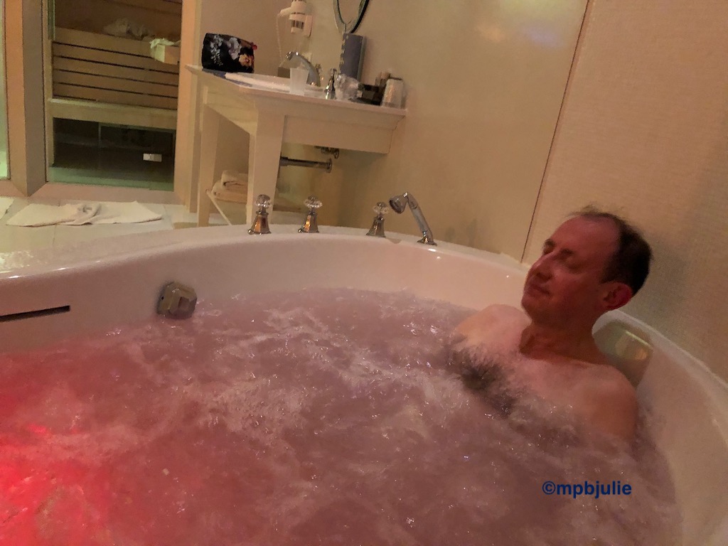 Master in a large jacuzzi bath