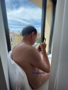 Master sitting on a wide window sill of a hotel room in Spain

