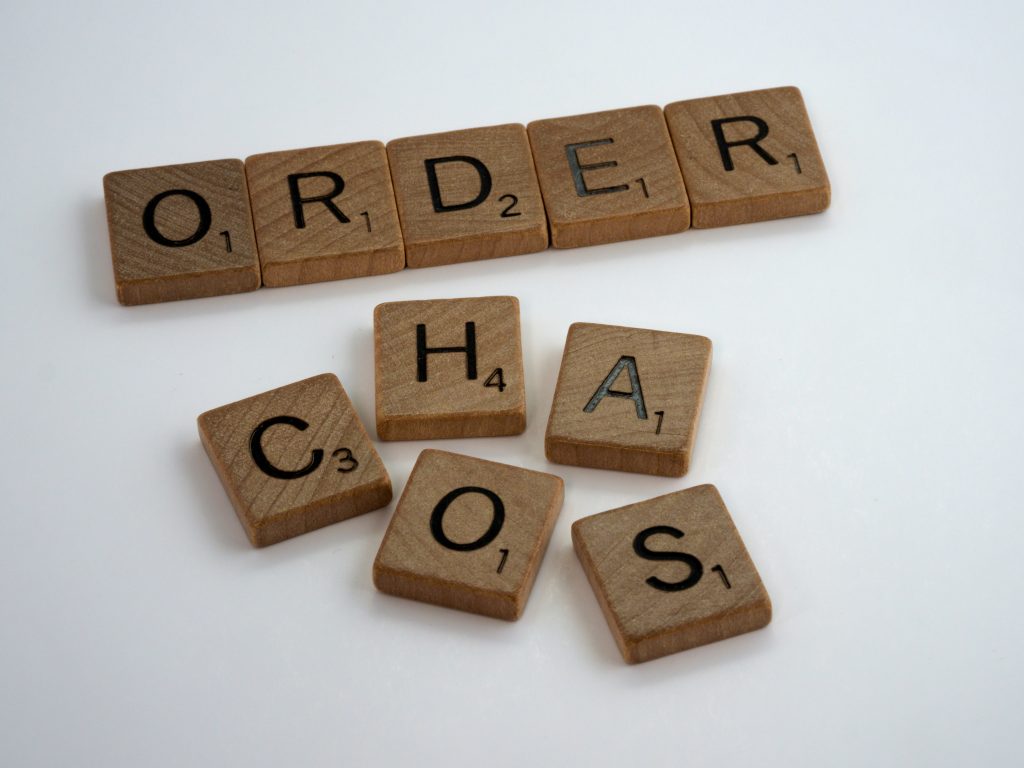 Scrabble words order and chaos. Chaos tiles are scattered while order is in a line